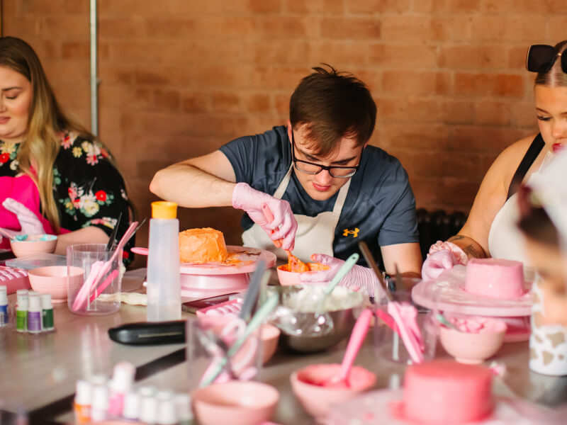 A group of people at a bento cake decorating class